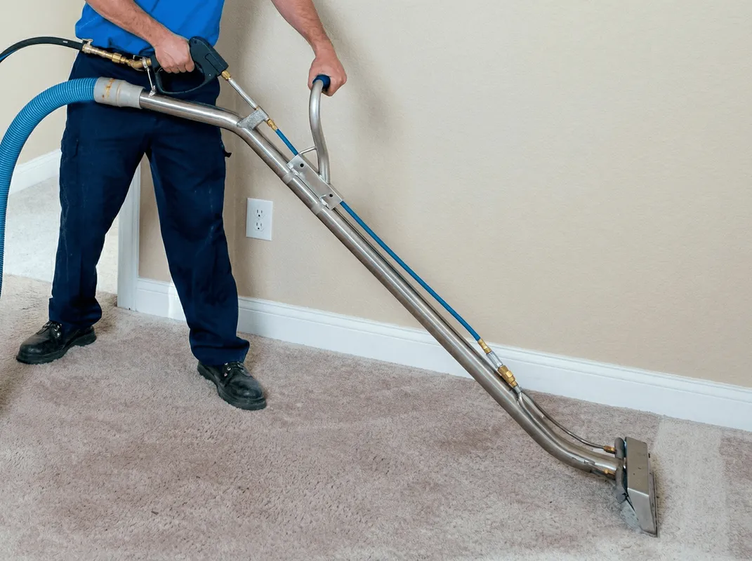 Professional operating a liquid removal machine on a carpeted floor in Sarasota, FL